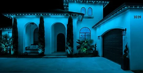 The home washed edge to edge in solid cyan from the roofline fixtures