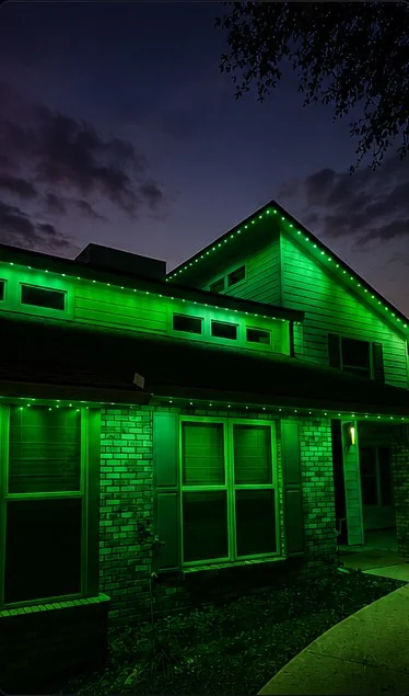 St. Patrick's Day roofline lighting scene on a two-story home