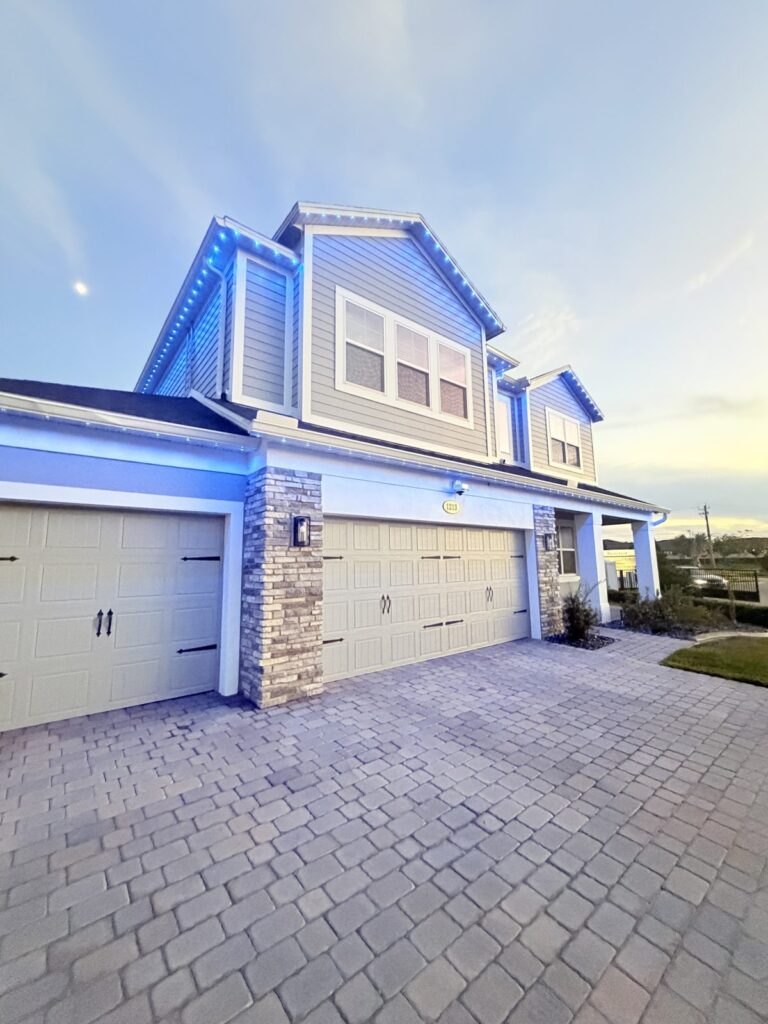Two story home washed in deep blue permanent lighting at dusk in Sanford, Florida
