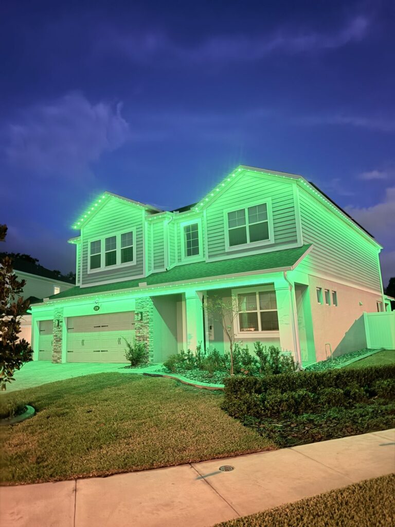 Home lit in emerald green at night in Sanford, Florida