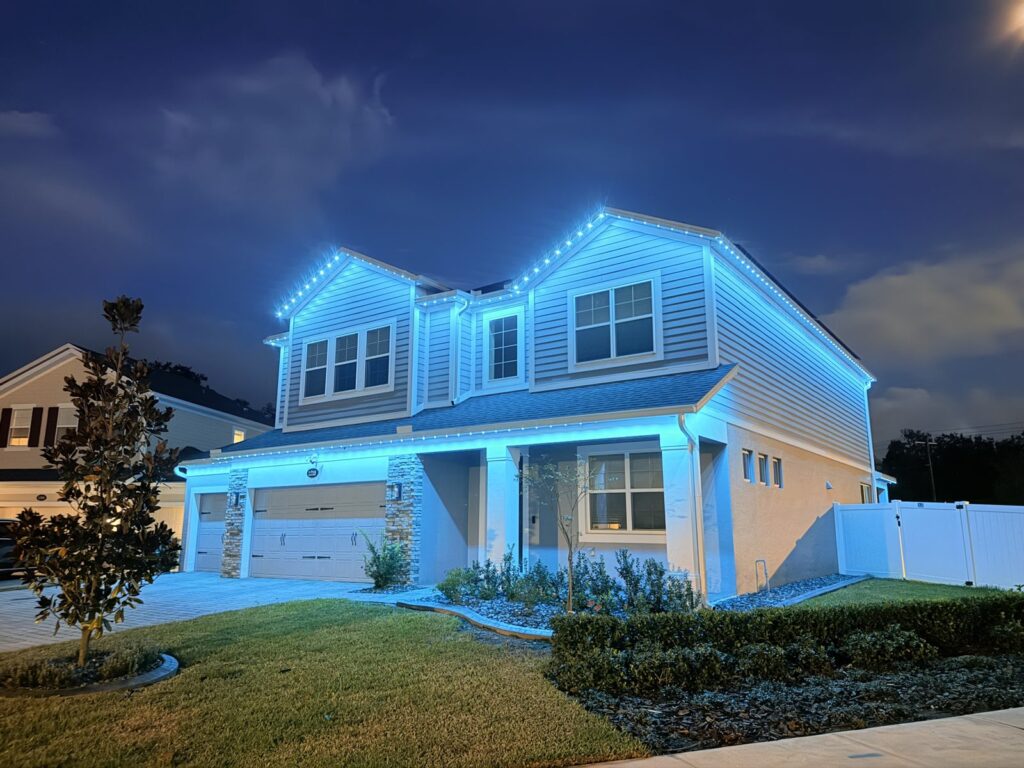 Home lit in ice blue at night in Sanford, Florida