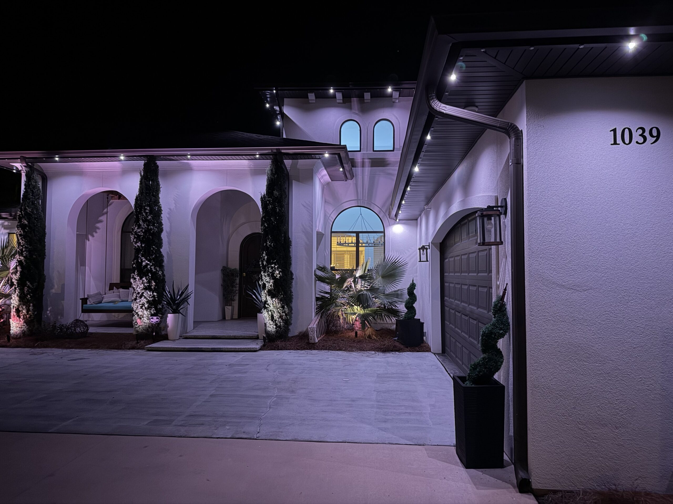 Roofline lighting on architectural down light pattern, one fixture lit for every several off, at 1039