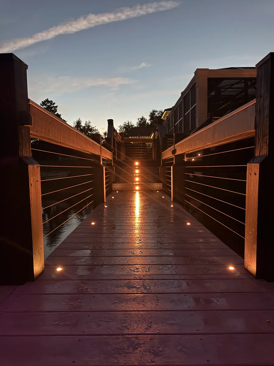 Dock walkway lit in amber — warm & welcoming