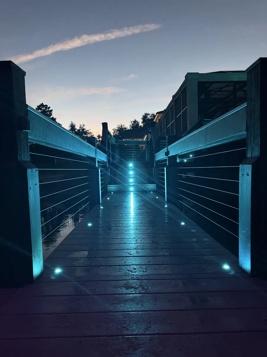 Dock walkway lit in aqua — cool water