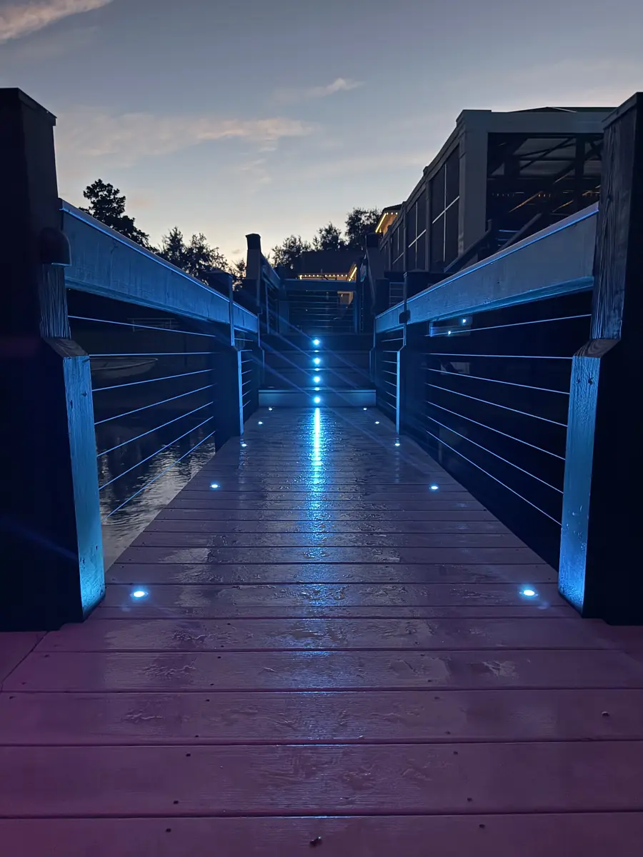 Dock walkway lit in blue — deep evening