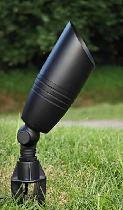 A Brighter Nights Lighting Technologies bullet up light on its ground stake, set into turf