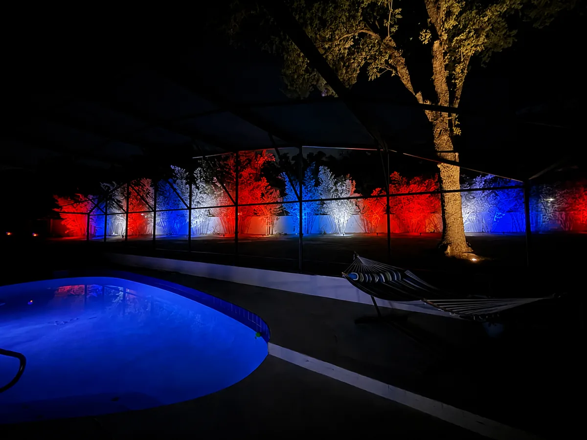 The same screened pool yard lit in red, white and blue for the 4th of July