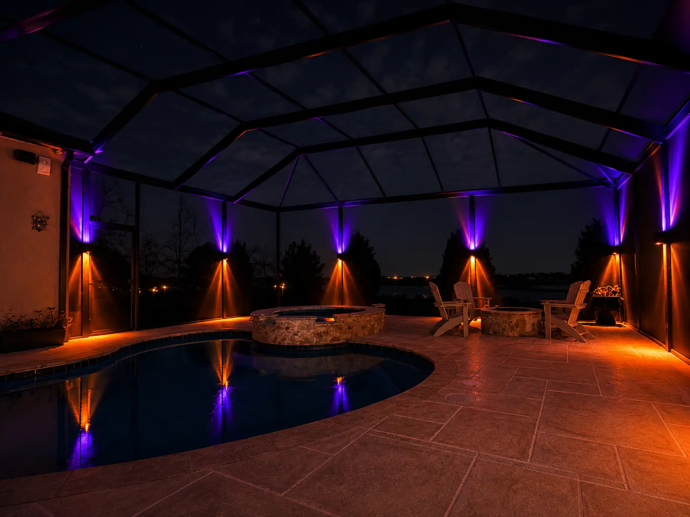 Sconce lighting on pool enclosure posts throwing purple upward and orange downward for Halloween