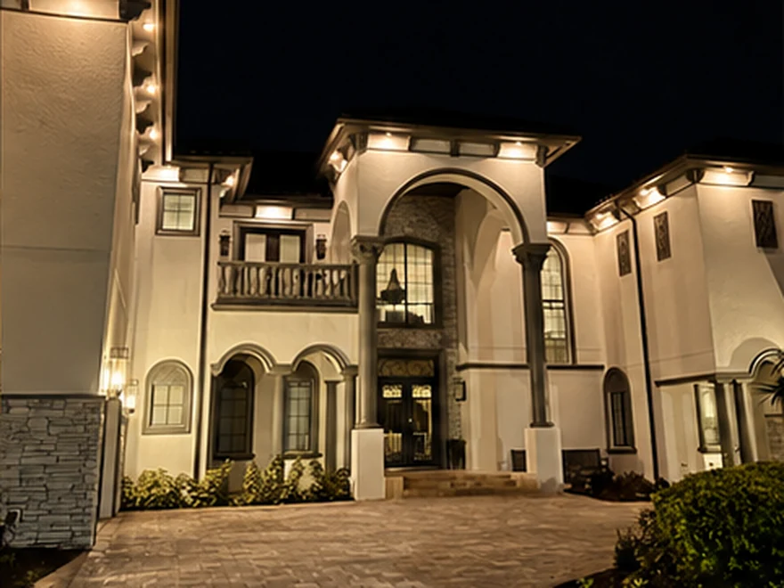 The same home at night with Brighter Nights soffit lighting at 3000K Soft White
