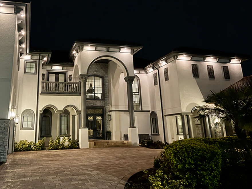 The same home at night with Brighter Nights soffit lighting at 5000K Bright White