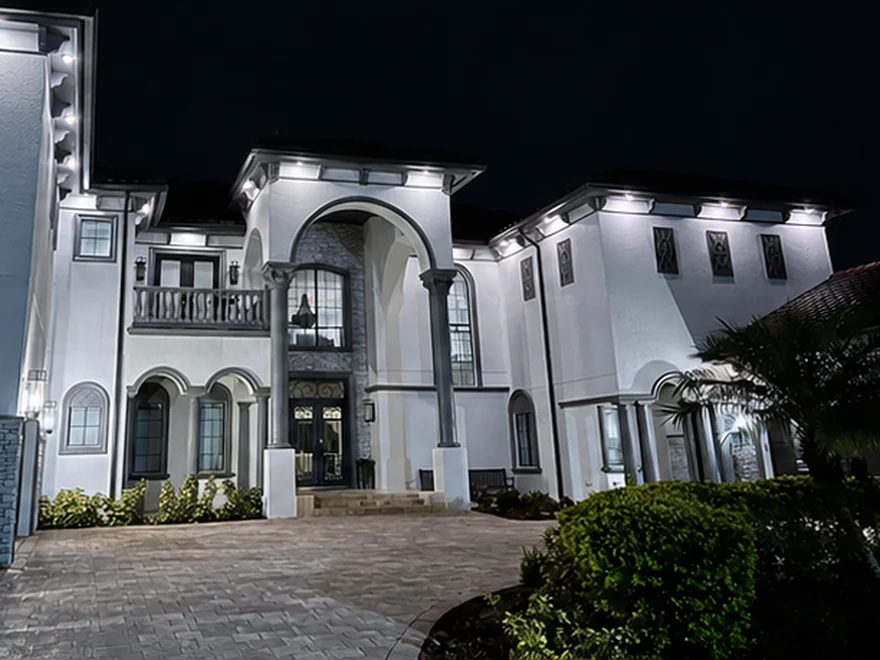 The same home at night with Brighter Nights soffit lighting at 6500K Cool White