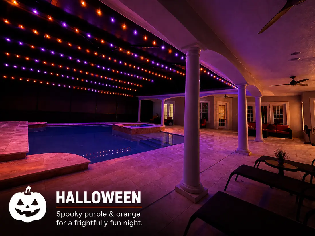 Halloween pool enclosure lighting: purple and orange BNLT track lights over a lanai pool at night