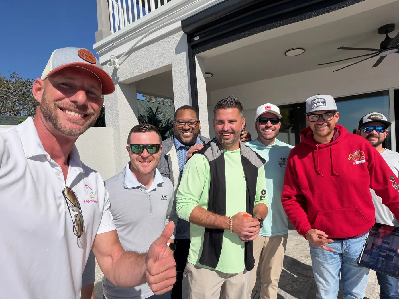 A group of contractors and distributor staff outside a completed home