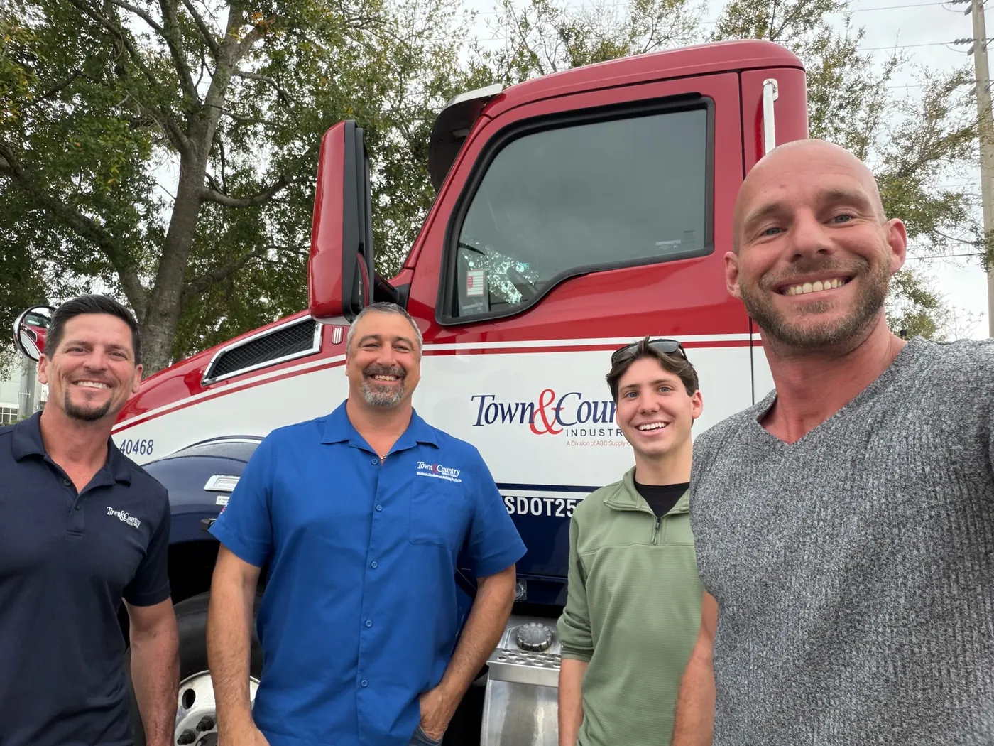 Distributor branch staff and Brighter Nights team beside a delivery truck